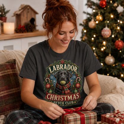 Model wearing a graphite Fetch Club t-shirt with a Labrador in a Christmas-themed scene