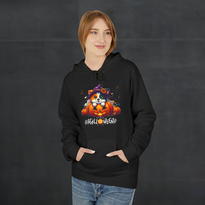 Woman wearing a black Halloween hoodie featuring a cute puppy in a witch hat sitting with pumpkins and spooky Halloween lettering, cozy festive dog lover hoodie mockup with casual autumn style.
