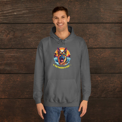 Man wearing a steel grey unisex college hoodie featuring vibrant dog artwork and motivational “Stay Pawsitive in Style” text.