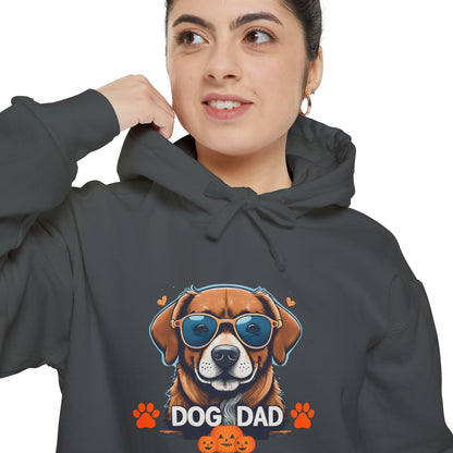Woman wearing a pepper unisex “Dog Dad” hoodie with colorful dog face artwork and retro typography, casual cozy hoodie mockup for dog lovers.