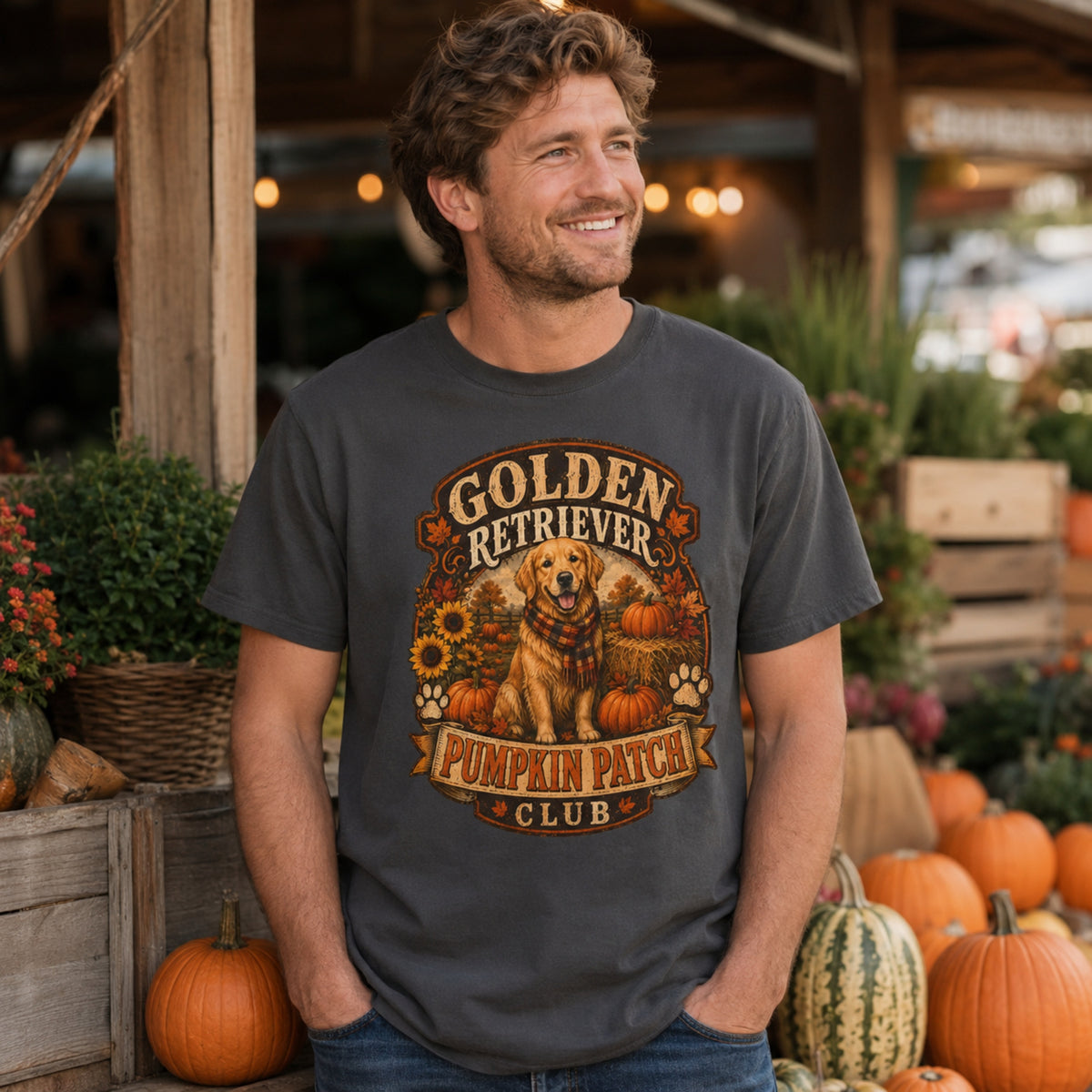 Model wearing a graphite Golden Retriever Pumpkin Patch t-shirt with a Golden Retriever at a pumpkin patch
