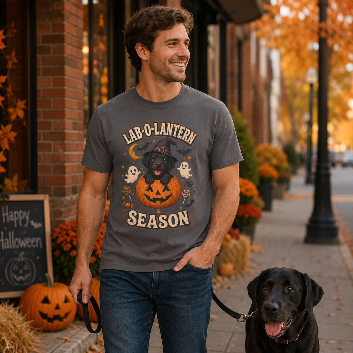 Model wearing a graphite Lab-O-Lantern Season t-shirt with a Black Labrador and pumpkin in a Halloween scene
