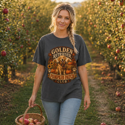 Model wearing a graphite Golden Retriever Pumpkin Patch t-shirt with a Golden Retriever at a pumpkin patch