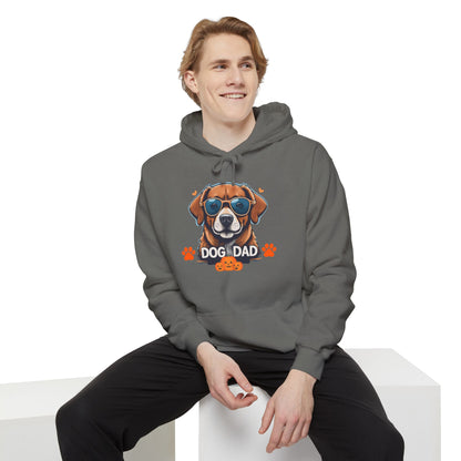 Man sitting while wearing a grey unisex “Dog Dad” hoodie featuring vibrant dog artwork, stylish dog lover hoodie mockup with relaxed streetwear fashion.