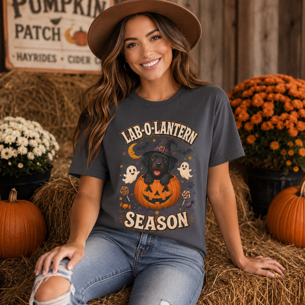 Model wearing a graphite Lab-O-Lantern Season t-shirt with a Black Labrador and pumpkin in a Halloween scene
