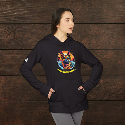 Woman modeling a black adidas unisex fleece hoodie featuring a colorful German Shepherd graphic and “Pawsitive Vibes” dog lover artwork against a rustic wooden background.
