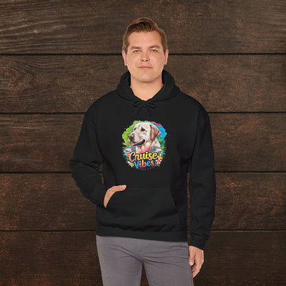 Man modeling a black unisex heavy blend hooded sweatshirt with vibrant Labrador “Cruise Vibes” artwork against a rustic wooden background.
