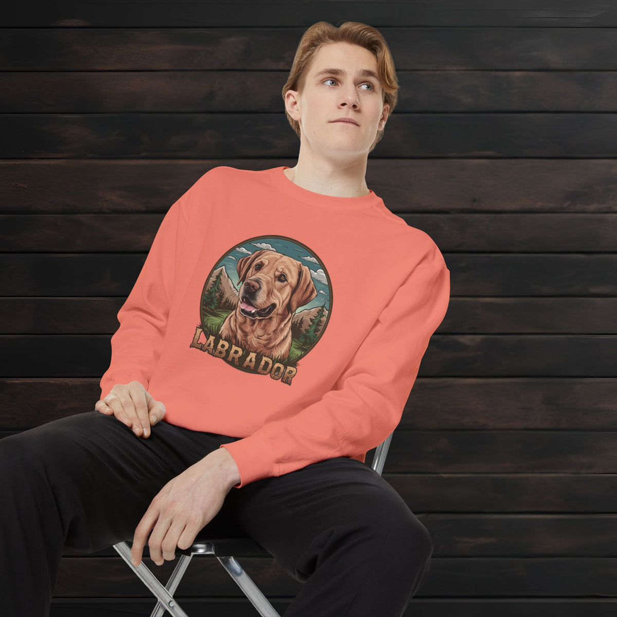 Man wearing a terracotta unisex garment-dyed crewneck sweatshirt featuring a Labrador Retriever illustration and relaxed fit design.