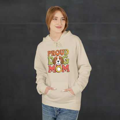 Woman wearing a sand-colored “Proud Dog Mom” hoodie with vibrant retro text design, cozy dog mom hoodie with casual autumn fashion look.