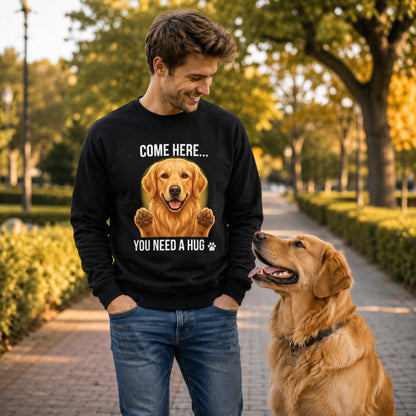 Man wearing a black Golden Retriever sweatshirt while walking with a real Golden Retriever dog in the park.