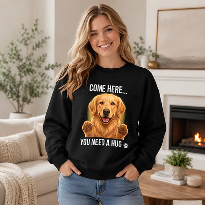 Woman wearing a black Golden Retriever sweatshirt with “Come Here You Need a Hug” design in a cozy home setting.
