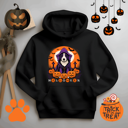 Black Halloween hoodie featuring a dog in a purple witch costume surrounded by jack-o’-lantern pumpkins, bats, and spooky Halloween graphics, festive dog lover hoodie flat lay mockup with trick-or-treat decorations.