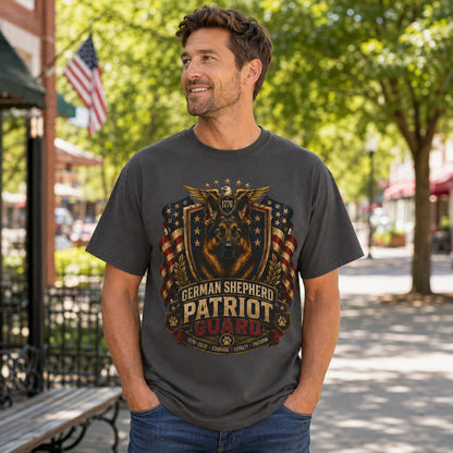 Man wearing a graphite German Shepherd Patriot Guard T-shirt with a German Shepherd patriotic crest design in an outdoor town street scene.