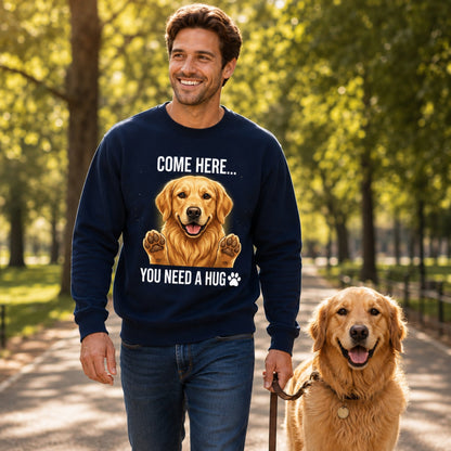 Man wearing a navy Golden Retriever sweatshirt while walking with a cute Golden Retriever dog in the park.