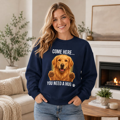 Woman wearing a navy Golden Retriever sweatshirt with “Come Here You Need a Hug” design in a cozy home setting.