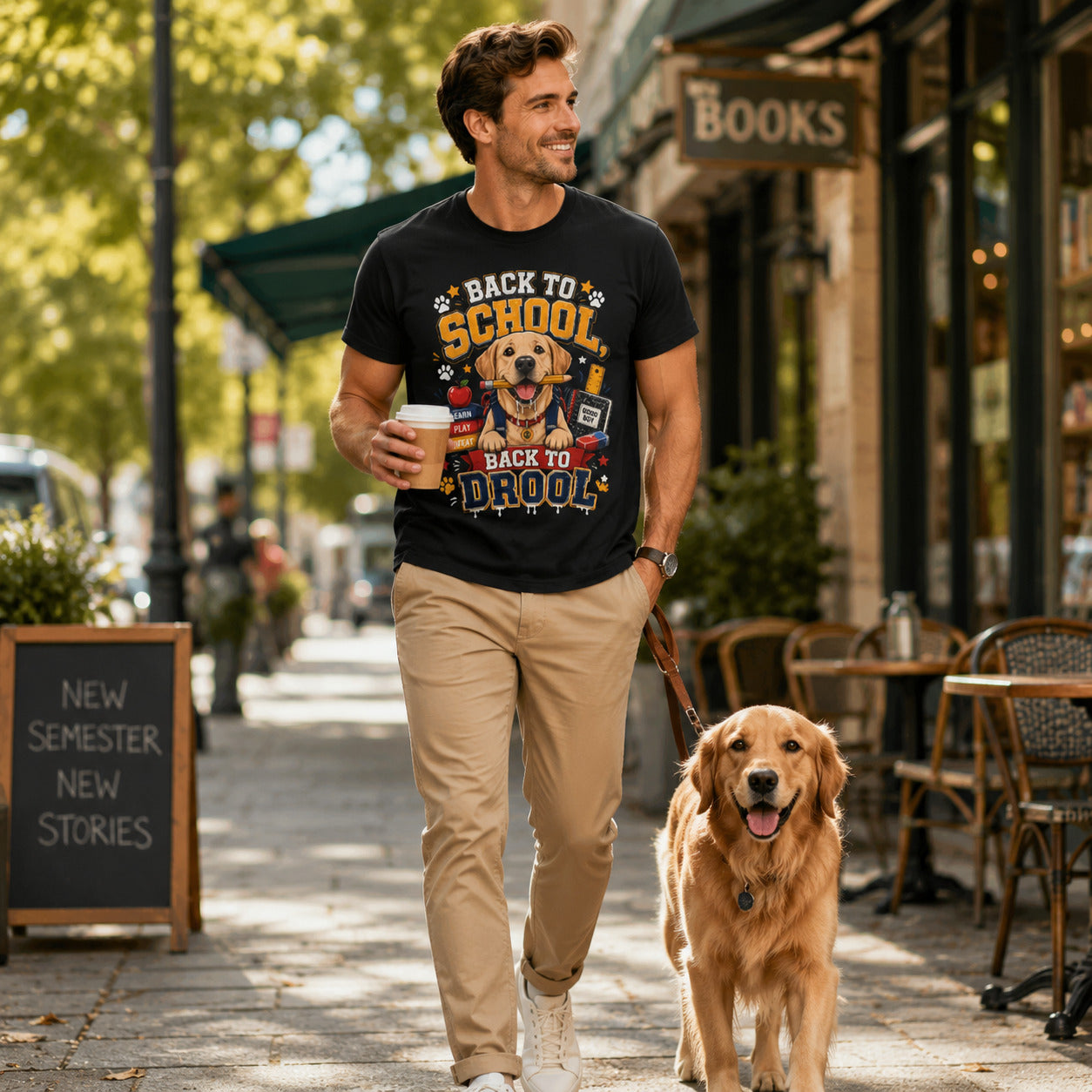 Man walking past a bookstore with his golden retriever, wearing black 'Back to School, Back to Drool' dog t-shirt