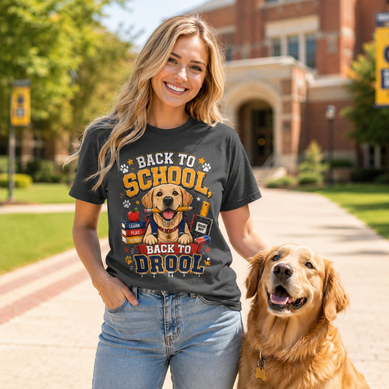 Woman walking a campus walkway with her golden retriever, wearing graphite 'Back to School, Back to Drool' dog t-shirt