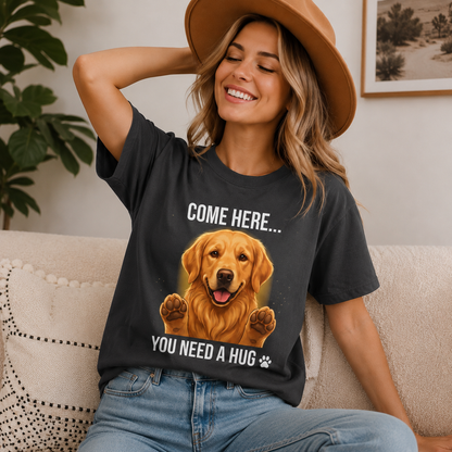 Woman wearing a graphite Come Here You Need a Hug t-shirt with a Golden Retriever in a casual indoor scene