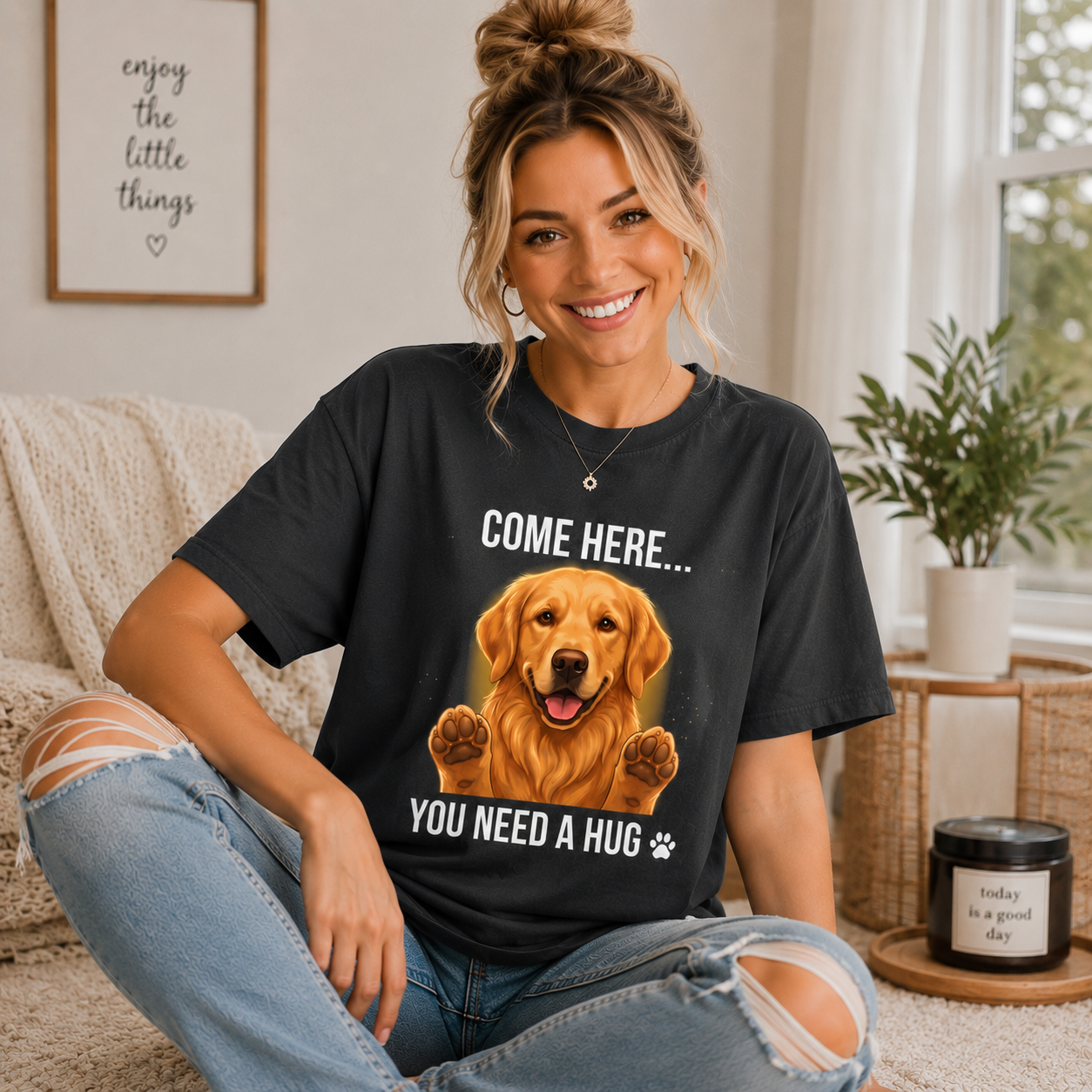 Woman wearing a graphite Come Here You Need a Hug t-shirt with a Golden Retriever in a cozy room