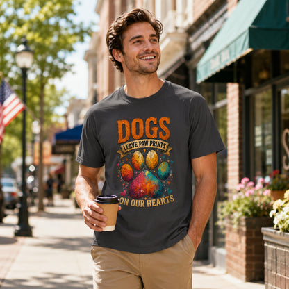 Man walking a street holding coffee near an American flag, wearing graphite 'Dogs Leave Paw Prints On Our Hearts' t-shirt