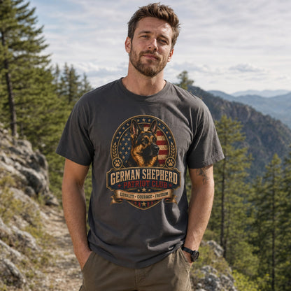 Man wearing a graphite German Shepherd Patriot Club T-shirt on a mountain trail.