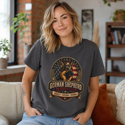 Woman wearing a graphite German Shepherd Patriot Club T-shirt in a casual loft home setting.