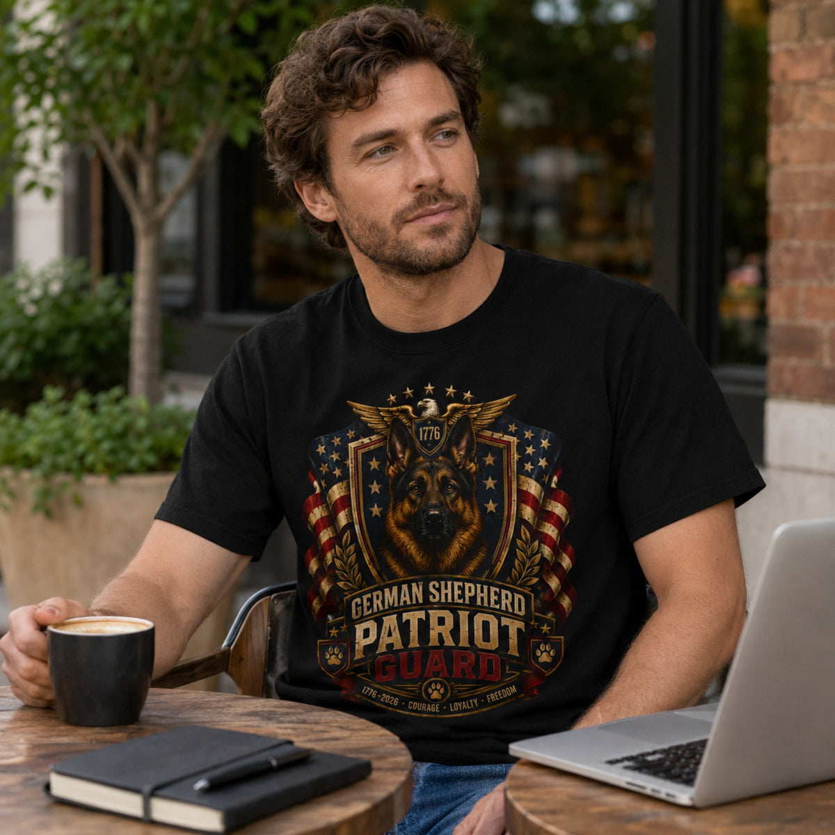 Man wearing a black German Shepherd Patriot Guard t-shirt with a German Shepherd at a cafe