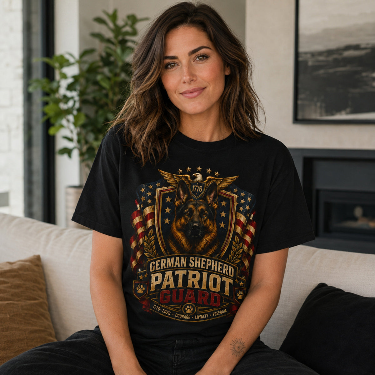 Woman wearing a black German Shepherd Patriot Guard t-shirt with a German Shepherd in a living room
