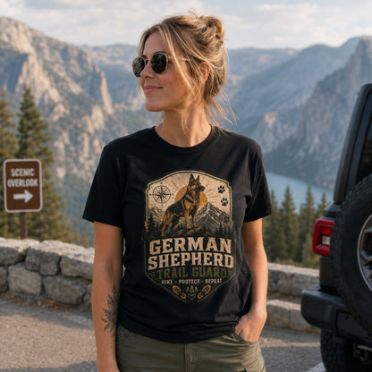 Woman wearing a black German Shepherd Trail Guard T-shirt at a scenic mountain overlook.