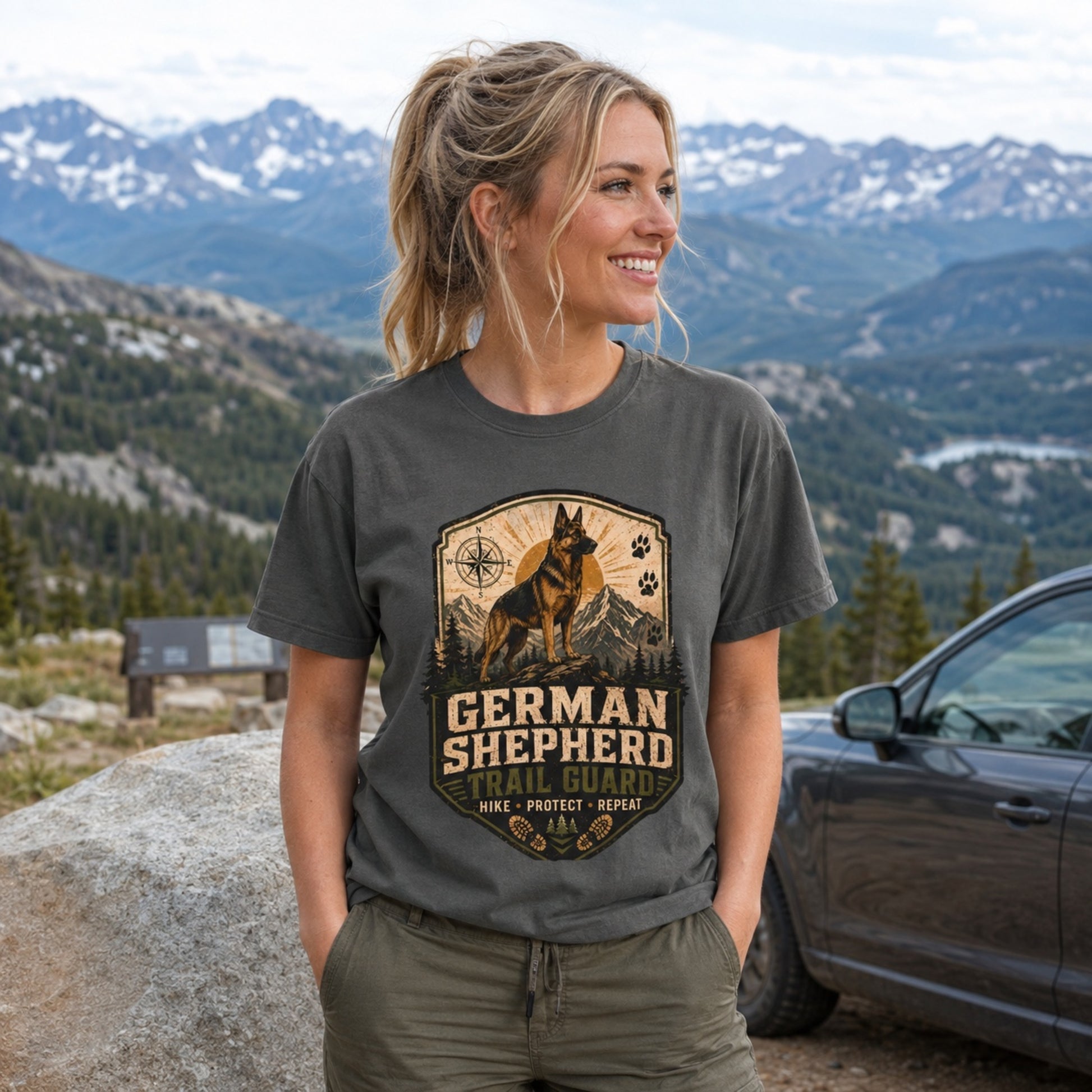 Woman wearing a pepper German Shepherd Trail Guard T-shirt at a mountain overlook.