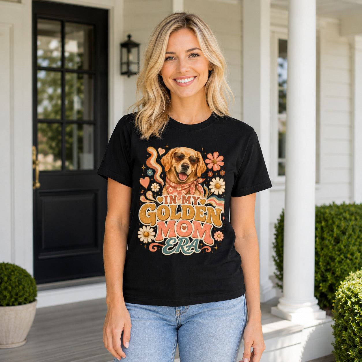 Woman standing on a porch wearing black 'In My Golden Mom Era' retro floral t-shirt