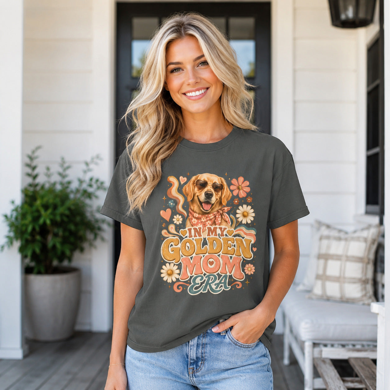 Woman standing on a porch wearing pepper 'In My Golden Mom Era' retro floral t-shirt