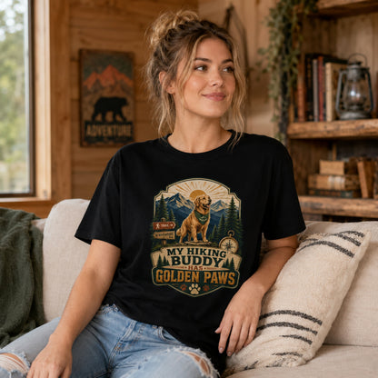 Woman wearing a black My Hiking Buddy Has Golden Paws T-shirt while sitting on a cabin sofa.