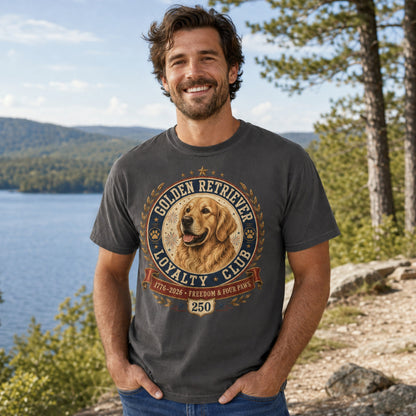 Man wearing a graphite Golden Retriever Loyalty Club T-shirt at a lakeside outdoor location.