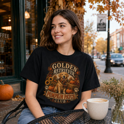 Model wearing a black Golden Retriever Pumpkin Patch t-shirt with a Golden Retriever at a pumpkin patch