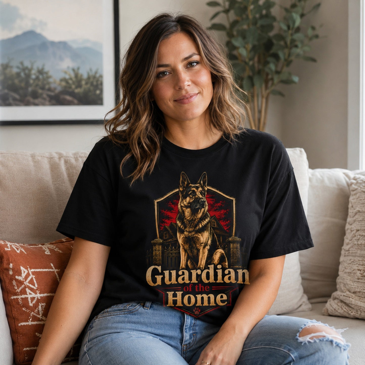 Woman wearing a black Guardian of the Home German Shepherd T-shirt while seated on a sofa.