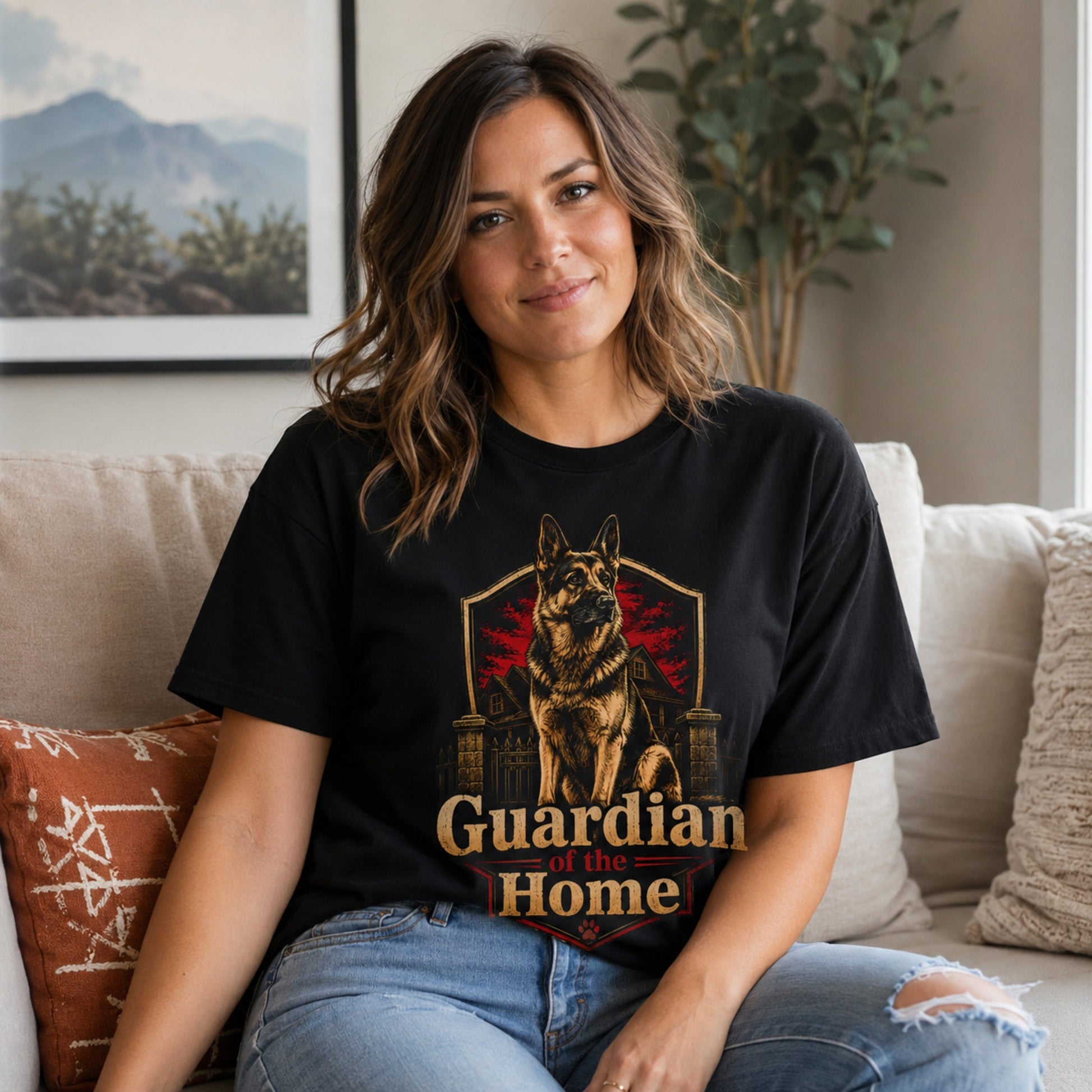 Woman wearing a black Guardian of the Home German Shepherd T-shirt while seated on a sofa.
