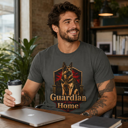 Man wearing a pepper Guardian of the Home German Shepherd T-shirt in a home office with coffee and laptop.