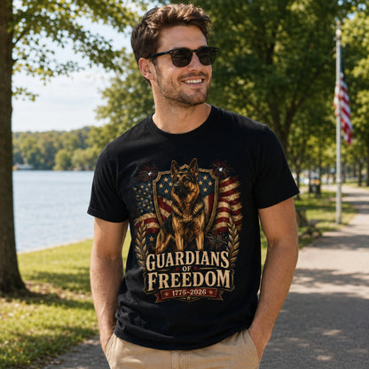 Man wearing a black Guardians of Freedom K-9 T-shirt with a German Shepherd patriotic graphic near a lakeside walking path.