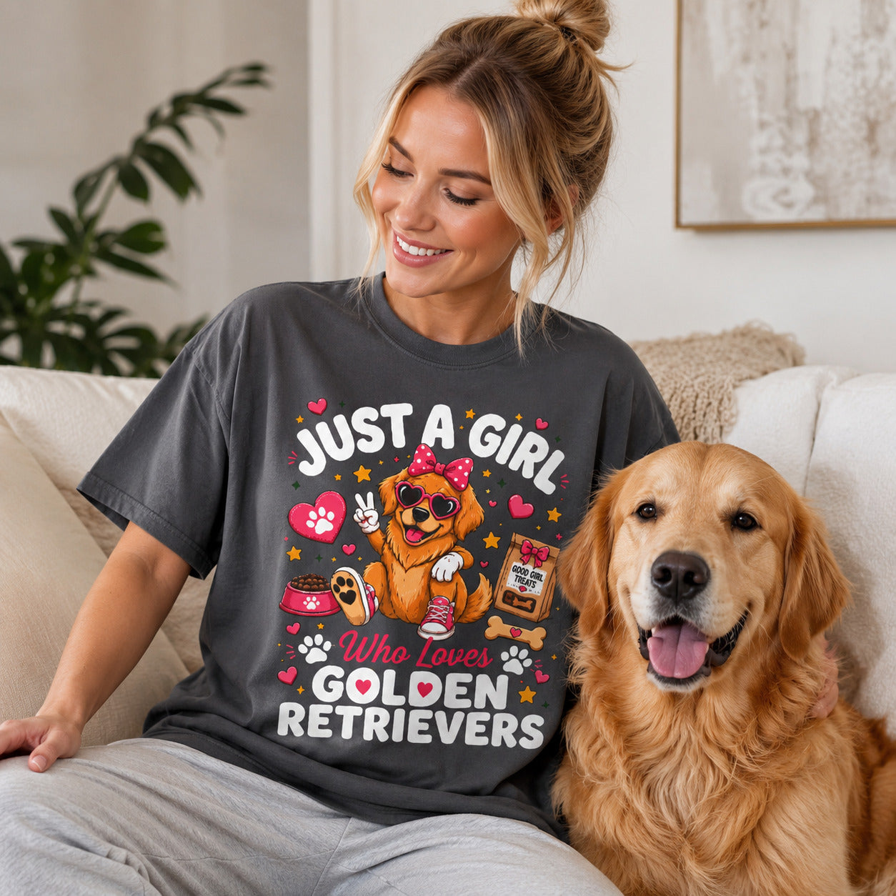Woman sitting on a couch with her golden retriever, wearing graphite 'Just A Girl Who Loves Golden Retrievers' t-shirt