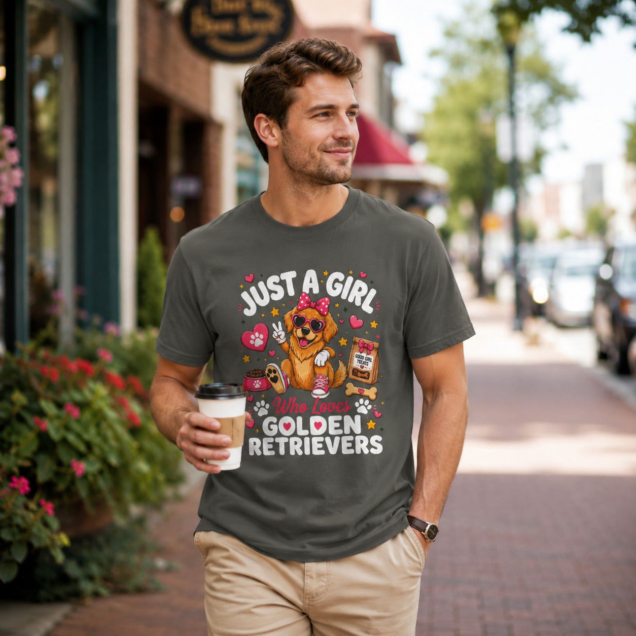 Man walking down a street holding coffee, wearing pepper 'Just A Girl Who Loves Golden Retrievers' t-shirt