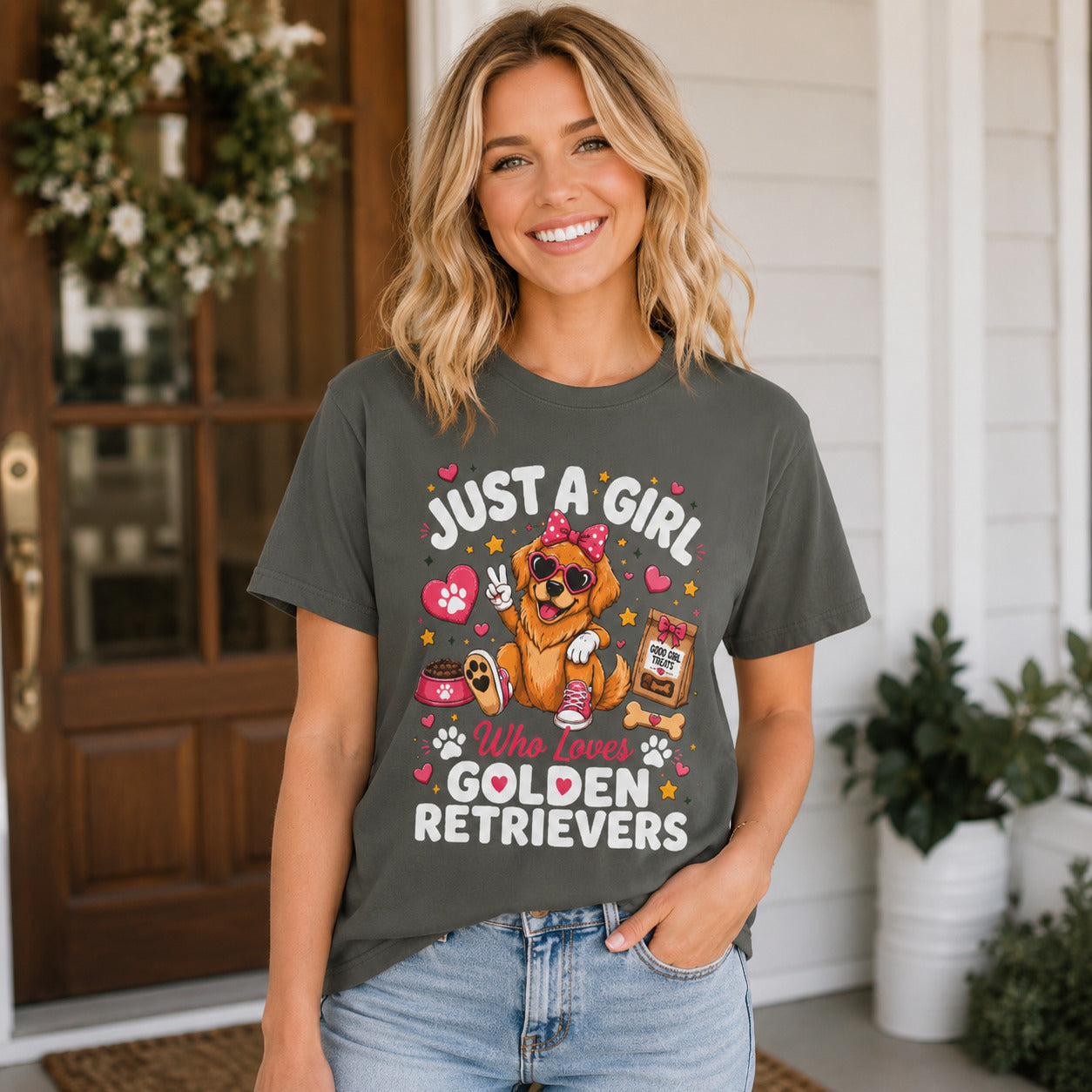 Woman standing on a porch surrounded by flowers, wearing pepper 'Just A Girl Who Loves Golden Retrievers' t-shirt