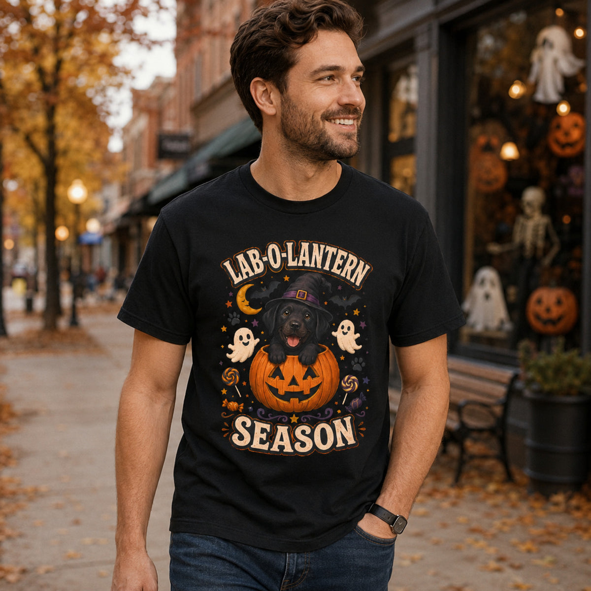 Model wearing a black Lab-O-Lantern Season t-shirt with a Black Labrador and pumpkin in a Halloween scene
