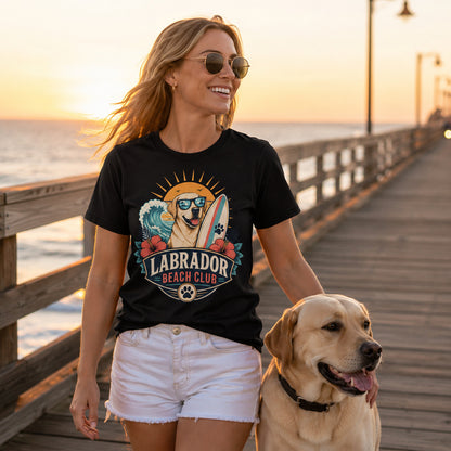 Model wearing a black Labrador Beach Club t-shirt with a Labrador in a beach scene