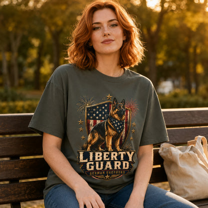 Woman sitting on a park bench with a tote bag while wearing a pepper Liberty Guard German Shepherd T-shirt.