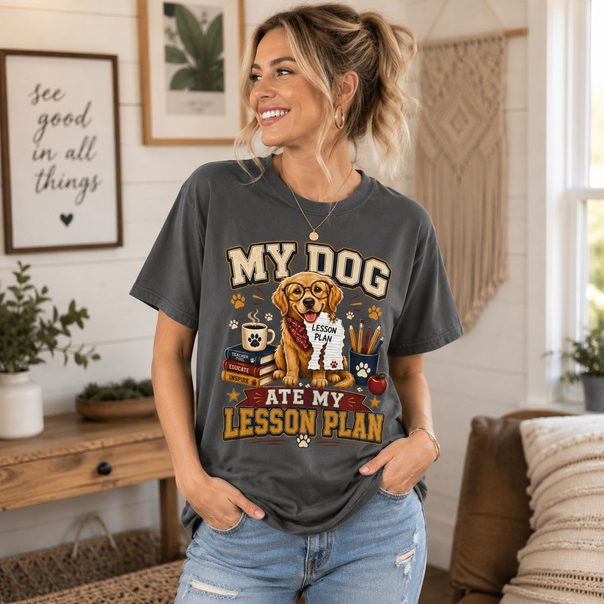 American woman wearing a Graphite Comfort Colors “My Dog Ate My Lesson Plan” Golden Retriever teacher T-shirt in a relaxed indoor lifestyle setting.