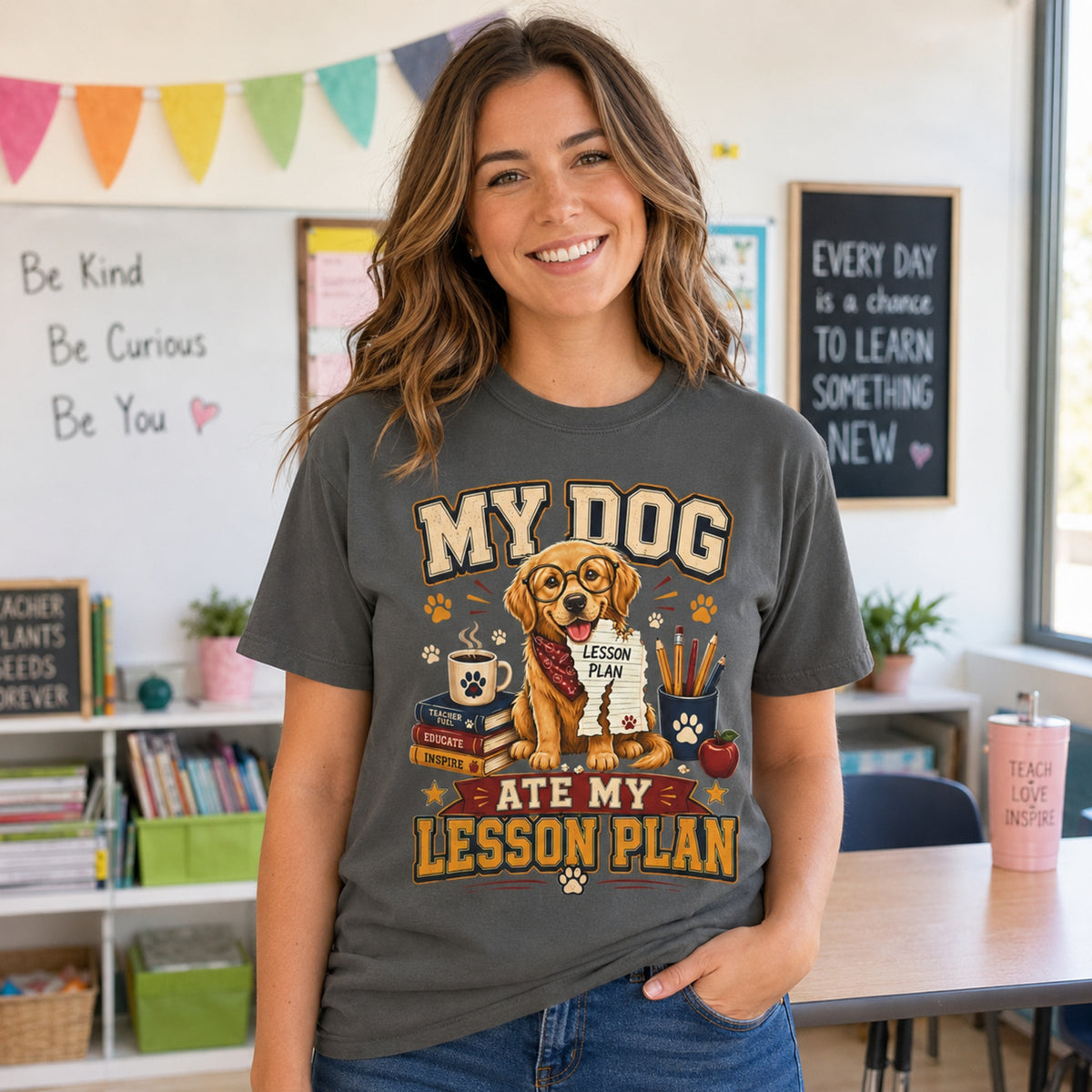 Woman teacher wearing a Pepper “My Dog Ate My Lesson Plan” T-shirt in a bright classroom with golden retriever teacher artwork.