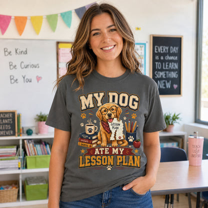 Woman teacher wearing a Pepper “My Dog Ate My Lesson Plan” T-shirt in a bright classroom with golden retriever teacher artwork.