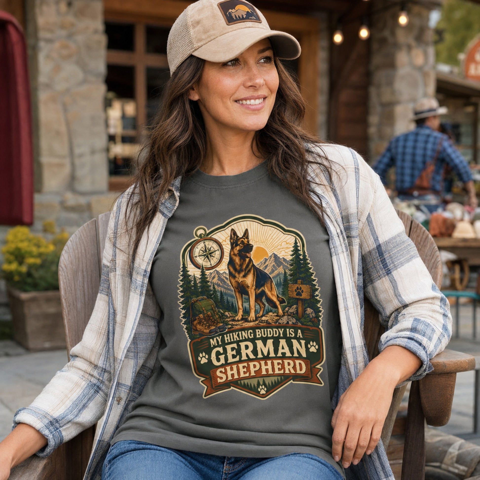 Woman wearing a pepper My Hiking Buddy German Shepherd T-shirt on a lodge patio.