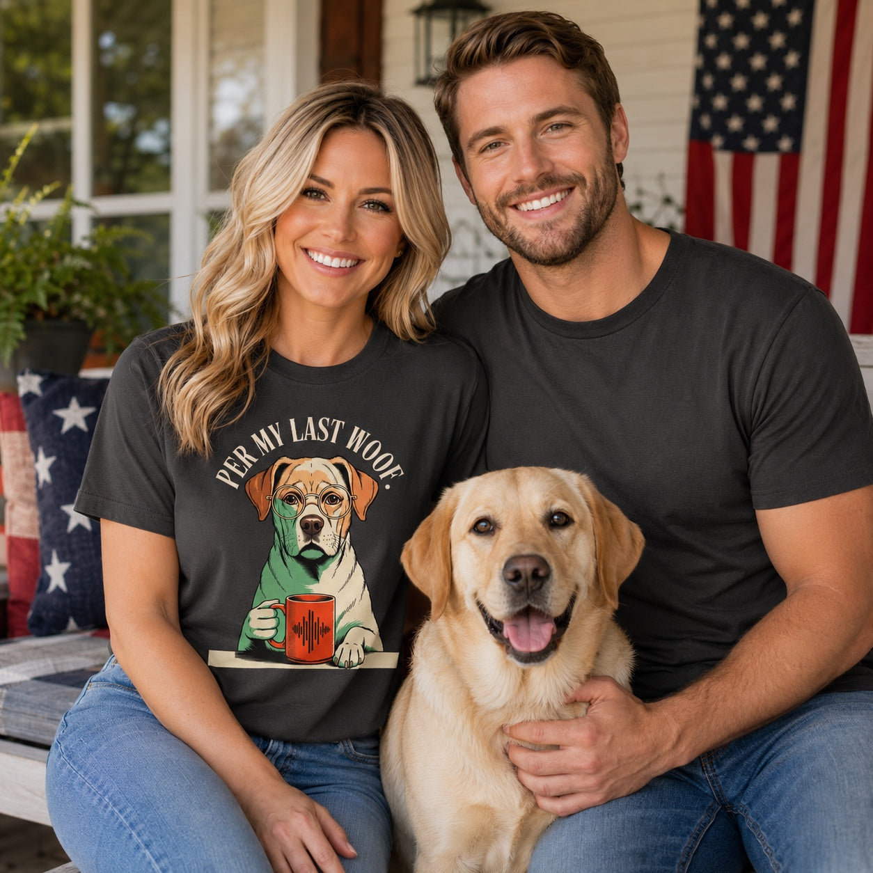 Couple sitting together with their Labrador on a porch with flag decor, wearing graphite 'Per My Last Woof' t-shirts